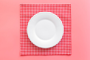 Empty plate on napkin - table setting for dinner. Overhead view