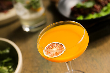 Refreshing orange cocktail served for one