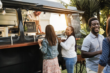 Multiracial people ordering gourmet food in front of food truck outdoor - Focus on african senior woman face