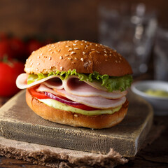 Homemade sandwich or burger with ham and pesto