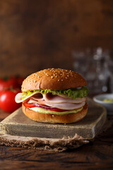 Homemade sandwich or burger with ham and pesto