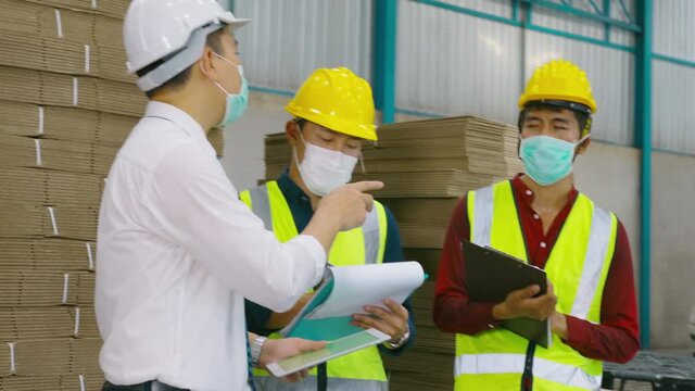 Engineer people are wearing  protective mask working in warehouse