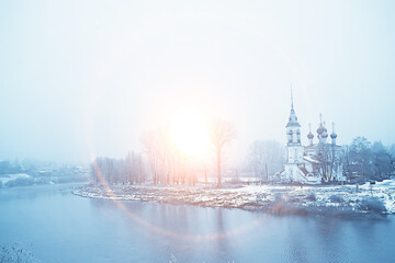 winter landscape church on the banks of the freezing river in vologda, christianity baptism russia...