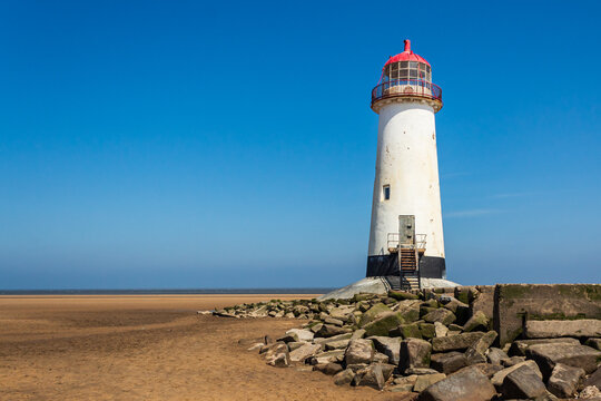Old lighthouse on the sandy shore. Point of Air, Wales.