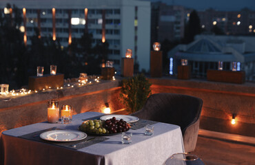 Beautiful view of modern cafe with outdoor roof terrace in evening