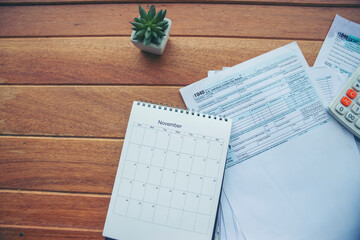 Top view of Individual Income Tax Return Form, calendar and calculator For who have income...