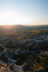 Vertical photo. Aerial view point of Love Valley Peri Bacalari Sunset over Red valley in Cappadocia canyon, mountains and balloons.. Nevsehir Province. Turkey