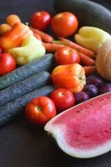 Various colorful summer fruit and vegetable on dark background. Selective focus.