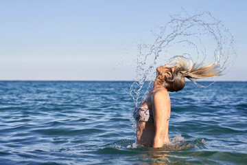 Women flipping hair in the sea
