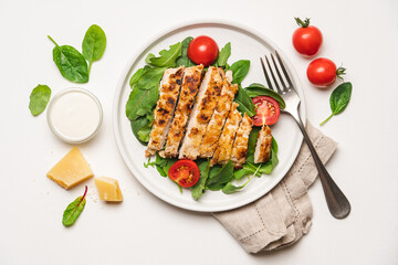 Chopped chicken breast steak with salad. White background with copy space