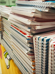 Stack notebook shop in paper art style. Many colorful notebooks on the shelves of the store. Stack of notebooks.
