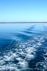 Rippled water in the wake of the Coochiemudlo ferry in the calm waters of Moreton Bay in Queensland Australia.