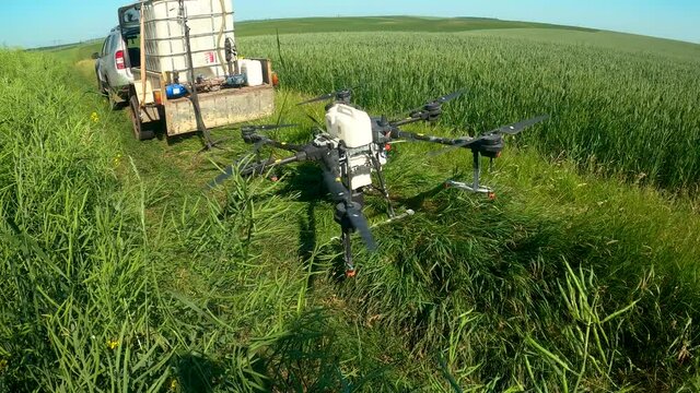 Agrodrone takes off on a field flying to spray field