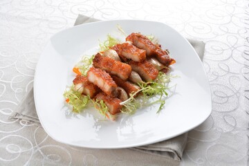 deep fried pork belly with garlic meat in white background asian halal menu