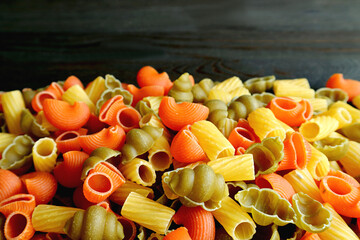 Pile of Three-color Dried Vegeroni Pasta on Black Background with Copy Space