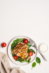Chopped chicken breast steak with salad. White background with copy space