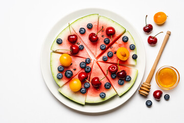 Naklejka na ściany i meble Watermelon pizza with fruits and berries. Healthy summer dessert on white background
