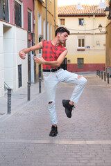 Young caucasian man with long false nails dancing at street, contemporary dance.