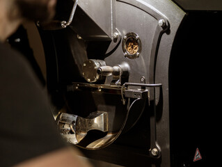 Modern coffee roasting machine with various metal parts