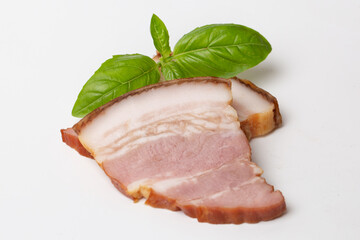 Smoked brisket pork loin decorated green basil leaf, isolated on white background. High resolution image.