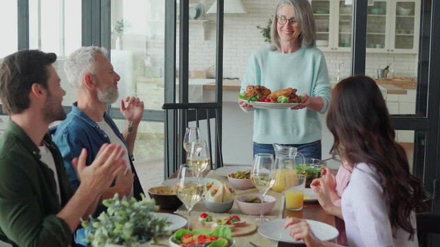 Happy multi-generation family enjoying dinner at home together