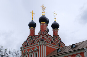 Fototapeta na wymiar Ancient and medieval Domes with golden crosses on the Orthodox Church against the blue sky with clouds.