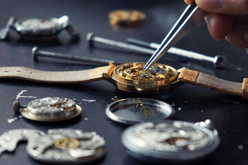Mechanical watch repair. Watchmaker repairs vintage mechanical watches. Watchmaker's workshop.