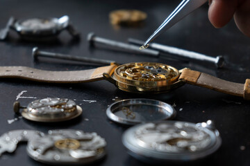 Mechanical watch repair. Watchmaker repairs vintage mechanical watches. Watchmaker's workshop.