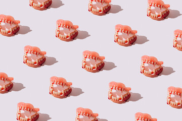 Pattern made of Vampire teeth or jaw on bright background. Halloween horrible creative concept....