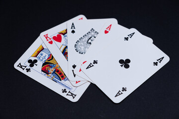Poker Cards with full house game on black background.