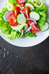 salad vegetable tomato, cucumber, pepper, onion, lettuce meal snack copy space food background rustic. top view keto or paleo diet veggie vegan or vegetarian food 