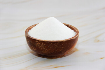 white crumbly granulated sugar in a decorative plate