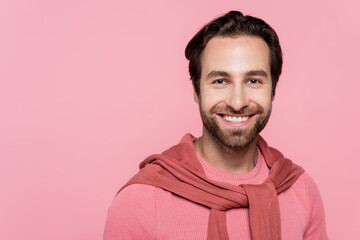 Obraz premium Portrait of young man smiling at camera isolated on pink
