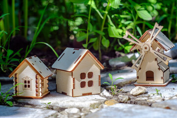 toy houses on a stone slab with greenery background
