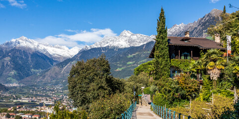 Panoramic view of Merano in Italy with mountains in background. - obrazy, fototapety, plakaty