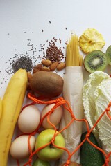 The concept of zero waste. Eco-friendly shopping, flat styling. Vegetables, fruits, eggs, pasta, legumes in a shopping bag on the table.