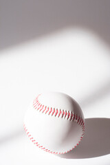 baseball ball with red threads on white paper background