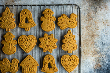Assorted Christmas gingerbread cookies on a metal cooling rack