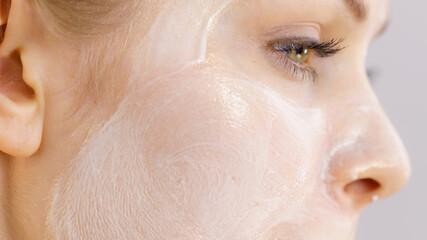 Fototapeta premium Girl with cream moisture cosmetic on face