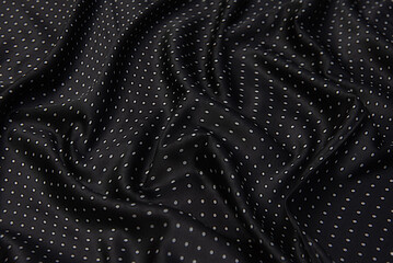 Fototapeta na wymiar The texture of the silk fabric is black to a white dot. Chiffon. Background, pattern.