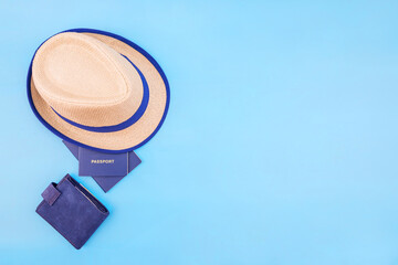 hat, passports and wallet on blue