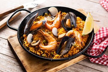 Traditional spanish seafood paella on wooden table	