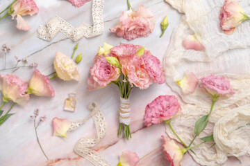 Fototapeta na wymiar Pink flowers bouquet on marble table