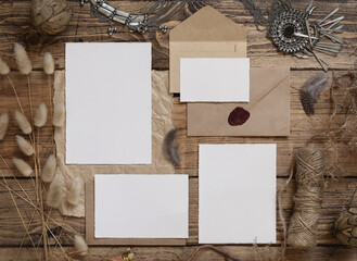 Wedding blank cards laying on a wooden table with bohemian decoration around