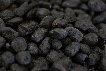 Black tektite stone or meteorite as background