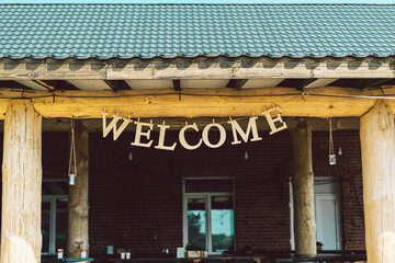 letters Welcome hanging on the terrace at the entrance to home