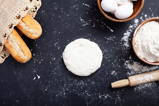 bakery, gold rustic loaves of bread and flour on black chalkbord backround