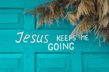 Text Jesus keep me going on a wooden turquoise background. Religious poster