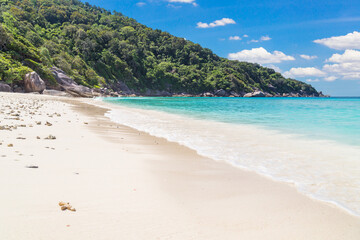 Beautiful sandy beach with wave crashing on sandy shore at Similan Islands.