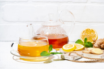 healthy tea for immunity with ginger, lemon and mint on white background, closeup